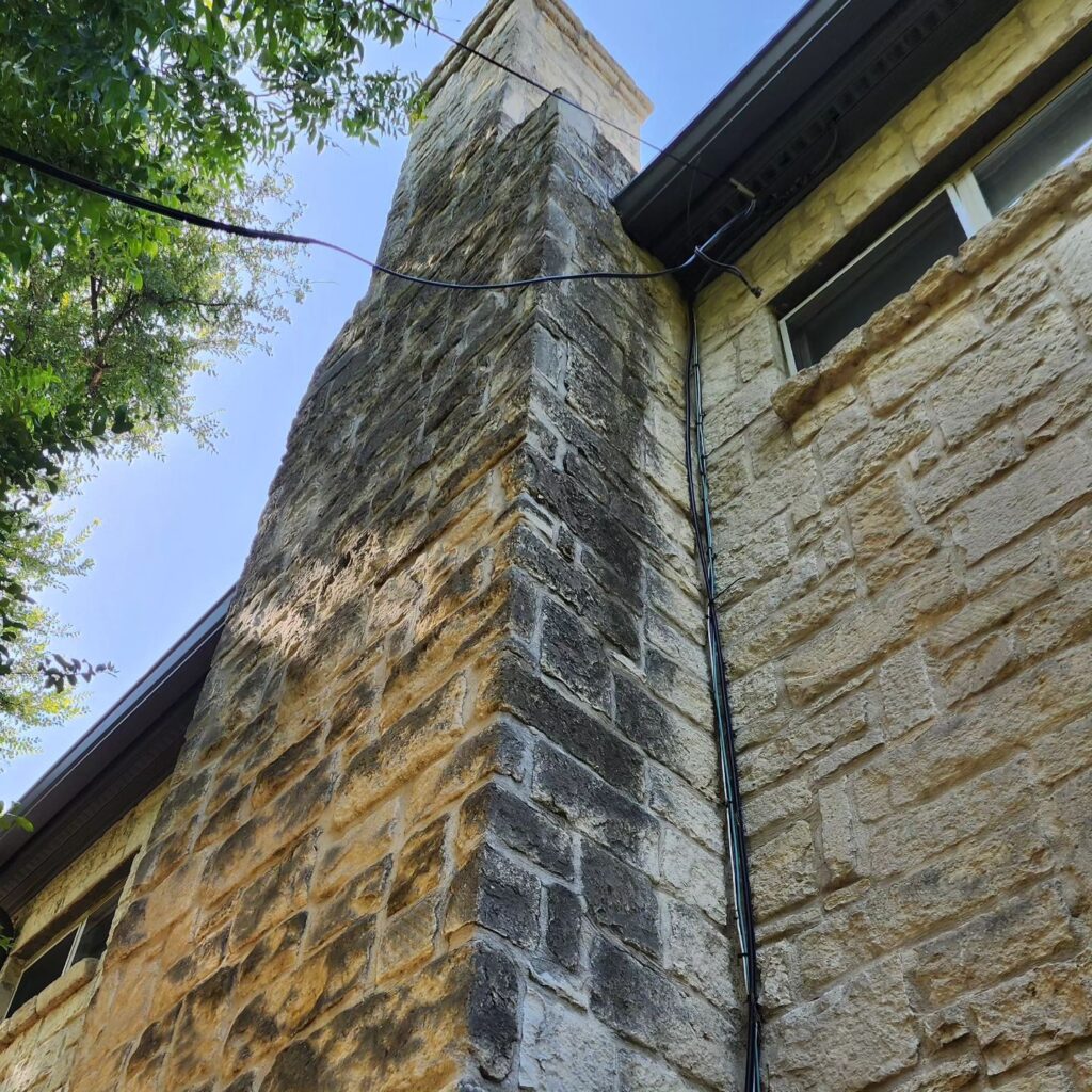 A brick building with a tall tower on the side.